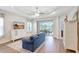 Living room with view of screened-in lanai and backyard, adjacent to kitchen and dining area at 13518 Circa Crossing Dr, Lithia, FL 33547