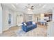 Open concept living room adjacent to kitchen with coffered ceilings and ceiling fan at 13518 Circa Crossing Dr, Lithia, FL 33547