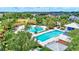 Aerial view of a zero entry community pool, splash pad, and lap pool with lush landscaping at 13518 Circa Crossing Dr, Lithia, FL 33547