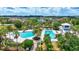 An aerial view of a neighborhood pool featuring lounge chairs, a pool house, and walking paths at 13518 Circa Crossing Dr, Lithia, FL 33547