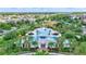 Stunning aerial view of a large community pool with palm trees, lounge chairs, and clubhouse at 13518 Circa Crossing Dr, Lithia, FL 33547