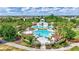 A beautiful zero entry community pool with slides and playground surrounded by lush landscaping at 13518 Circa Crossing Dr, Lithia, FL 33547
