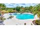 Beautiful swimming pool surrounded by palm trees and lounge chairs, perfect for relaxation and recreation at 13518 Circa Crossing Dr, Lithia, FL 33547