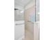 This tiled shower features a glass enclosure, grab bars, and sleek fixtures for ease of use at 13518 Circa Crossing Dr, Lithia, FL 33547