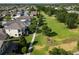 Aerial view of a suburban neighborhood with well-maintained homes, green spaces, and tree-lined streets at 14204 Barrington Stowers Dr, Lithia, FL 33547