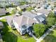 Overhead view of a two-story home with landscaping, patio, and a lush lawn in a suburban neighborhood at 14204 Barrington Stowers Dr, Lithia, FL 33547