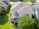 Elegant home showcases a welcoming balcony and landscaped garden, offering a serene outdoor living space at 14204 Barrington Stowers Dr, Lithia, FL 33547