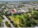 An aerial view highlighting a property within a well-planned community, adjacent to a green space at 14204 Barrington Stowers Dr, Lithia, FL 33547