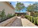 Beautifully landscaped backyard with a stone retaining wall, firepit and a peaceful seating area at 14204 Barrington Stowers Dr, Lithia, FL 33547
