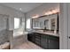 Elegant bathroom featuring a soaking tub, glass shower, and a double vanity with granite countertops at 14204 Barrington Stowers Dr, Lithia, FL 33547