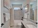 Inviting bathroom featuring granite counters, tiled shower, and modern fixtures at 14204 Barrington Stowers Dr, Lithia, FL 33547