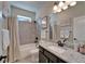 Cozy bathroom featuring granite counters, tiled shower, and modern fixtures at 14204 Barrington Stowers Dr, Lithia, FL 33547