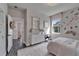Bedroom with floral wallpaper, large mirror and open doorway at 14204 Barrington Stowers Dr, Lithia, FL 33547