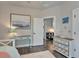 Bedroom with wooden floors, stylish dresser, and a bright airy atmosphere at 14204 Barrington Stowers Dr, Lithia, FL 33547
