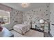 Bright bedroom with floral wallpaper, white trim and decor at 14204 Barrington Stowers Dr, Lithia, FL 33547