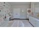 Bedroom featuring floral wallpaper, white trim and furniture at 14204 Barrington Stowers Dr, Lithia, FL 33547