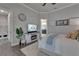 Comfortable bedroom with a cozy fireplace, large TV, and views of the bathroom and laundry room at 14204 Barrington Stowers Dr, Lithia, FL 33547