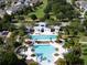 Detailed aerial shot of a community swimming pool with slides, lounge chairs, and manicured landscaping at 14204 Barrington Stowers Dr, Lithia, FL 33547