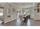 Dining room features hardwood floors, chandelier lighting, wallpaper, and elegant furnishings at 14204 Barrington Stowers Dr, Lithia, FL 33547