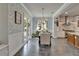 Dining room showcases sliding glass doors, hardwood floors, wallpaper, and views to the backyard at 14204 Barrington Stowers Dr, Lithia, FL 33547