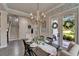 Elegant dining area with hardwood floors, chandelier, wallpaper, and French door access to the outside at 14204 Barrington Stowers Dr, Lithia, FL 33547