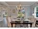Dining area featuring decorative wallpaper, hardwood floors, a chandelier, and an outdoor view at 14204 Barrington Stowers Dr, Lithia, FL 33547