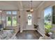 Bright entryway features hardwood floors, decorative lighting, and views of the beautifully landscaped front yard at 14204 Barrington Stowers Dr, Lithia, FL 33547