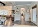 Spacious foyer with wood flooring, arched doorway, and views into the kitchen and dining area at 14204 Barrington Stowers Dr, Lithia, FL 33547