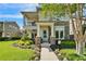 Charming home featuring a stone facade, manicured landscaping, and a welcoming light blue front door at 14204 Barrington Stowers Dr, Lithia, FL 33547