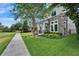 Beautiful front exterior view showcasing the landscaped yard, stone accents, and inviting walkway at 14204 Barrington Stowers Dr, Lithia, FL 33547