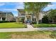Charming home with a stone facade, manicured landscaping, and a welcoming light blue front door at 14204 Barrington Stowers Dr, Lithia, FL 33547