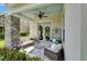 Cozy front porch featuring comfortable seating, decorative plants, and stone accents for a relaxing outdoor space at 14204 Barrington Stowers Dr, Lithia, FL 33547