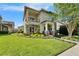 Two-story home with stone accents, a balcony, and beautiful landscaping enhancing the property's curb appeal at 14204 Barrington Stowers Dr, Lithia, FL 33547