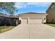 Double garage with a long driveway and well-manicured landscaping providing ample parking and curb appeal at 14204 Barrington Stowers Dr, Lithia, FL 33547