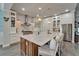 Spacious kitchen with a large marble island, stainless steel appliances, and custom white cabinetry at 14204 Barrington Stowers Dr, Lithia, FL 33547