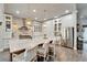 Bright kitchen featuring island with seating, stainless appliances, white cabinets, and tile backsplash at 14204 Barrington Stowers Dr, Lithia, FL 33547