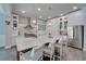 Bright kitchen featuring island with seating, stainless appliances, white cabinets, and tile backsplash at 14204 Barrington Stowers Dr, Lithia, FL 33547