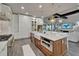 Open kitchen showcases a central island, marble counters, stainless steel appliances, and stylish lighting at 14204 Barrington Stowers Dr, Lithia, FL 33547