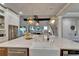 Bright kitchen with stainless steel appliances, hardwood floors, island with marble counter, and open concept design at 14204 Barrington Stowers Dr, Lithia, FL 33547
