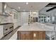 Gourmet kitchen featuring professional-grade appliances, a large center island, and pendant lighting at 14204 Barrington Stowers Dr, Lithia, FL 33547