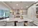 Bright kitchen featuring large island, modern lighting, white cabinets, and stainless appliances at 14204 Barrington Stowers Dr, Lithia, FL 33547