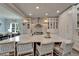 Bright kitchen featuring island with seating, stainless appliances, white cabinets, and modern lighting at 14204 Barrington Stowers Dr, Lithia, FL 33547