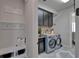 Well-organized laundry room features modern appliances, custom cabinetry, and ample storage space for convenience at 14204 Barrington Stowers Dr, Lithia, FL 33547