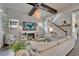 Comfortable living room with fireplace, TV, and plenty of seating, and open to staircase at 14204 Barrington Stowers Dr, Lithia, FL 33547