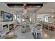 Open-concept living room with fireplace, beamed ceilings, and seamless flow to the kitchen and dining area at 14204 Barrington Stowers Dr, Lithia, FL 33547