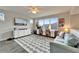 Comfortable living room with a work-from-home space, TV, lots of light, and hardwood flooring at 14204 Barrington Stowers Dr, Lithia, FL 33547