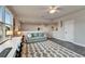 A comfortable living room with a sofa, a rug and a desk near the window at 14204 Barrington Stowers Dr, Lithia, FL 33547