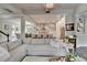 Bright open concept living room leading to kitchen and featuring a large comfortable sofa at 14204 Barrington Stowers Dr, Lithia, FL 33547