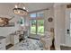 Charming office space with plenty of natural light, a decorative chandelier, and a custom desk at 14204 Barrington Stowers Dr, Lithia, FL 33547