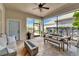 Covered patio with fire pit, dining area, and comfortable seating, perfect for outdoor entertaining at 14204 Barrington Stowers Dr, Lithia, FL 33547